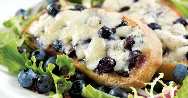 Sweet Ermite–blueberry crostini on a bed of greens